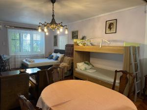 a living room with a table and a dining room at Zeleno i plavo in Kraljevica