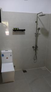 a bathroom with a shower and a toilet in it at Adam's Palm Resort in Talaimannar +94 photos