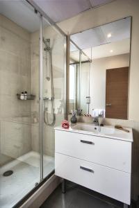 a bathroom with a white sink and a shower at Pierre & Vacances Barcelona Sants in Barcelona +69 photos