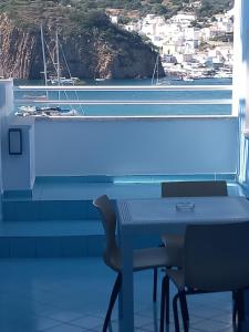a table and chairs in a room with a view of a harbor at Hotel La Baia in Ponza