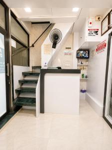 a store with a counter and stairs in a building at Andheri-69-Dormitory in Mumbai