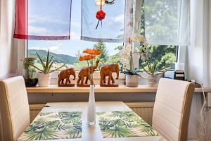 a dining room table with a figurine of elephants in a window at Ferienappartement in Black Forest in Baiersbronn