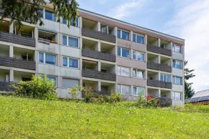 an apartment building on top of a grassy hill at Ferienappartement in Black Forest in Baiersbronn