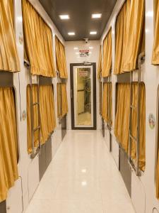 a corridor of a train with yellow curtains at Andheri-69-Dormitory in Mumbai +1 photo