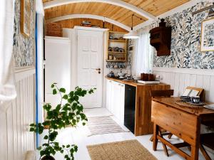 a small kitchen with a table and a counter at Tiny House Zajączki nad Narwią in Zajączki