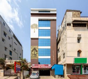 a building with a mural on the side of it at Hotel Aditya Premier in Guntūr