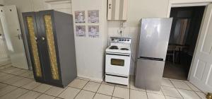 a kitchen with a stove and a refrigerator at Kapokbos in Sutherland +22 photos