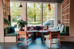 a living room with a couch and a table and chairs at ibis Martigues Centre in Martigues