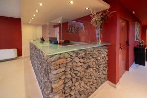 a lobby with a stone counter with a vase on it at MIL810 Ushuaia Hotel in Ushuaia