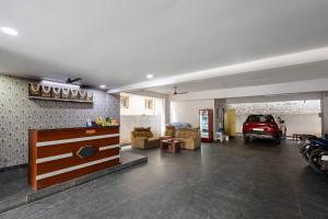 a living room with a car in a garage at Hotel Aditya Premier in Guntūr +21 photos