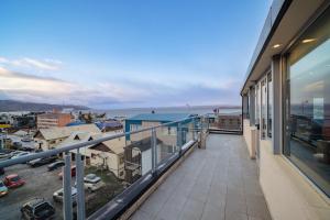 a balcony with a view of a city at MIL810 Ushuaia Hotel in Ushuaia