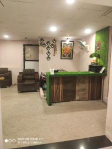 a lobby with a green counter in a room at Sahyadri Lodge Yermala in Yermala