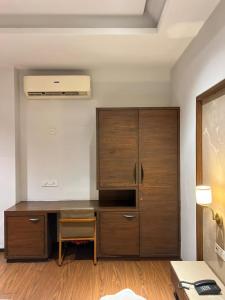 a desk and a cabinet in a room at DK Club & Resort in Bārdoli +4 photos