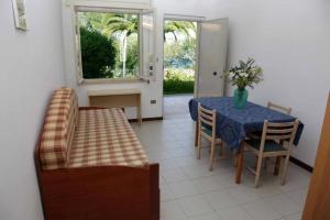 a dining room with a blue table and chairs at Tropea Residence - Pace in Tropea