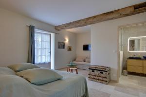 a bedroom with a bed and a living room at Cloffy et son Domaine in Nouans-les-Fontaines