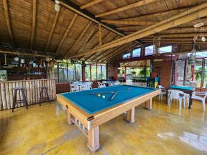 a pool table in the middle of a room at Finca Hotel Caracolí I A 15 Minutos del Parque del Café in Montenegro