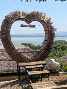 a circular sculpture of a heart with a bench at Sky Beach Resort in Kisumu +8 photos
