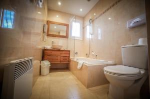 a bathroom with a toilet and a tub and a sink at Castellu Rossu in Lucciana