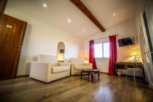 a living room with two chairs and a table at Castellu Rossu in Lucciana