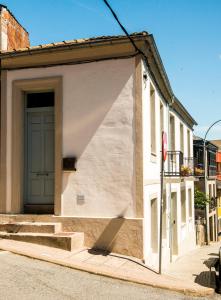 a building with a door and stairs on a street at A Calexa Sarria nº4 in Sarria +7 photos