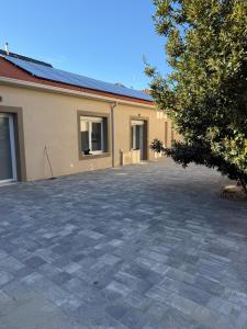 a brick parking lot in front of a building at Artexia residence DIAMANTE A1 in Valenza