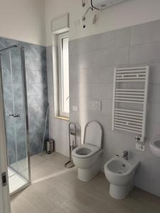 a bathroom with a toilet and a sink and a shower at Artexia residence DIAMANTE A1 in Valenza