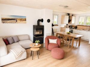a living room with a couch and a table at Inselheimat Dranske in Dranske