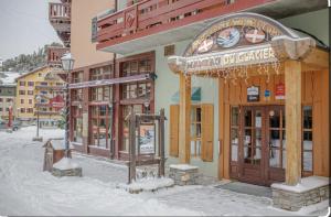 a building with a gazebo in the snow at Studio Premium ARC 1950 in Bourg-Saint-Maurice