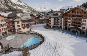 a resort in the mountains with snow on the ground at Studio Premium ARC 1950 in Bourg-Saint-Maurice