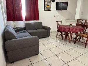 a living room with a couch and a table at DEPARTAMENTOS LALO in Zihuatanejo