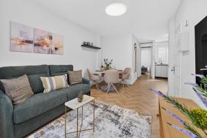 a living room with a couch and a table at Coast Suites in Alcalá +34 photos