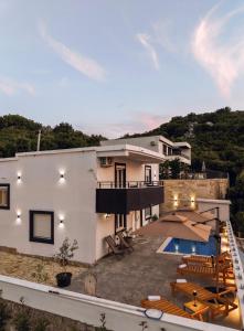 a large white house with a swimming pool at Villa Beyond Bar in Bar