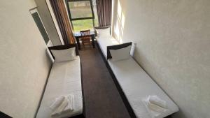 three bunk beds in a room with a table at Sohil Hotel in Stantsiya Kyzyl-Tukumachi