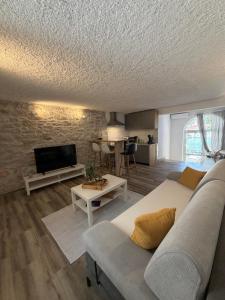 a living room with a couch and a tv at Apartmani Brač in Pučišća