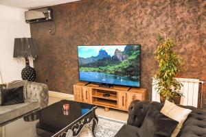a living room with a flat screen tv at Villa Beyond Bar in Bar