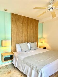 a bedroom with a bed and a ceiling fan at Anah Suites by Las Flores Vacation Rentals in Playa del Carmen +60 photos