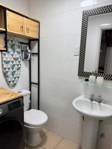 a bathroom with a toilet and a sink at Casa 2 dormitorios - Punta Arenas - Río Seco in Punta Arenas +36 photos