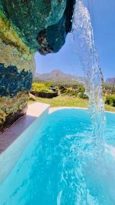 a plunge pool with a water fall into a pool at Finca Maracuya in El Paso