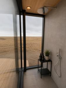 a bathroom with a shower with a view of the desert at Camp Boutique in Gaulverjabær