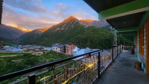 a balcony of a building with a view of a mountain at LAP Stays - Wanderer's Nest in Chitkal +42 photos