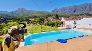 a swimming pool with a waterfall in a villa at Finca Maracuya in El Paso