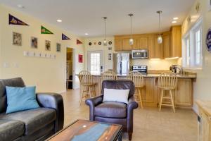 a living room with a couch and chairs and a kitchen at Pool, Dock + Rooftop Views! Bohannon Getaway in Bohannon