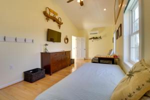 a bedroom with a bed and a tv on the wall at Pool, Dock + Rooftop Views! Bohannon Getaway in Bohannon