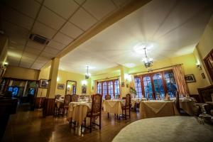 a restaurant with tables and chairs in a room at Castellu Rossu in Lucciana