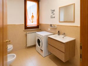 a bathroom with a washing machine and a sink at Casa Iris in Montepulciano