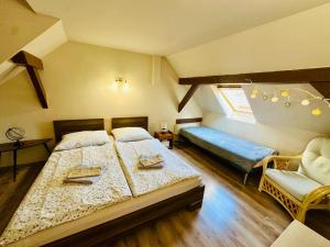 a bedroom with two beds and a window at Mendi in Štúrovo