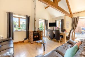 a living room with a couch and a fireplace at 3 Bed in Whitchurch Canonicorum oc-43395 in Whitchurch Canonicorum