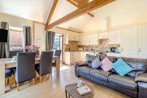 a living room with a couch and a table at 3 Bed in Whitchurch Canonicorum oc-43395 in Whitchurch Canonicorum