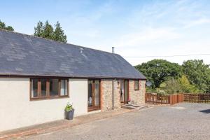 a brick house with a black roof at 3 Bed in Whitchurch Canonicorum oc-43395 in Whitchurch Canonicorum