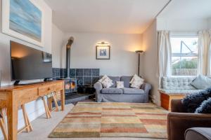 a living room with a television and a couch at 5 Bed in Beadnell oc-24955 in Beadnell